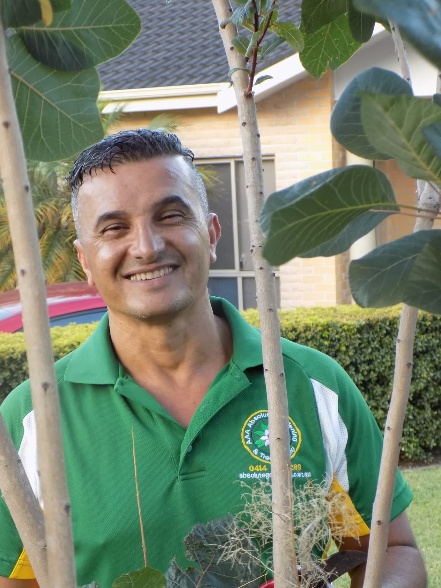 David, founder of Absolute Tree & Garden Services, among garden plants