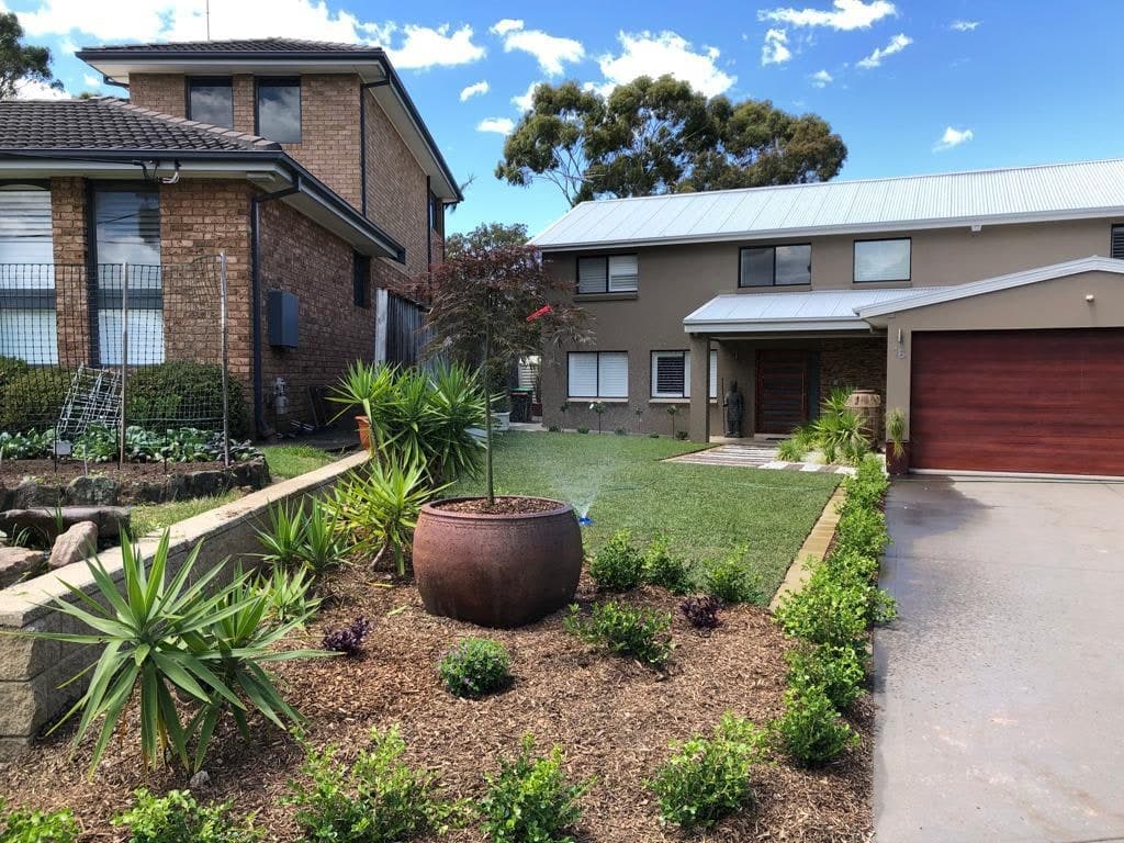 New lawn, mulch and planting around a feature pot