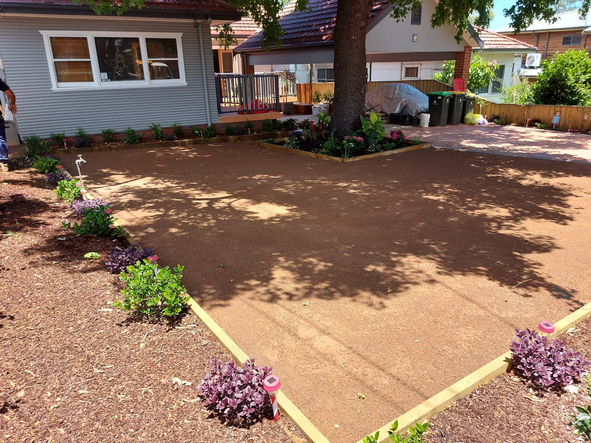 New planting and mulch along the side of a restored front garden